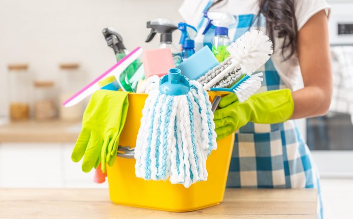 Bucket,Full,Of,House,Clenaing,Stuff,On,A,Kitchen,Desk